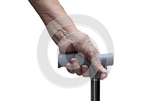 Closeup of senior hand holding a walking stick or a cane, isolated on white background. Medical and healthcare concept.