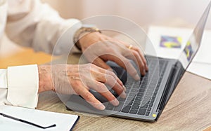 Closeup Of Senior Man`s Hands Working Typing On Laptop, Cropped