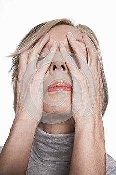 Closeup Of Senior Woman With Hands On Face
