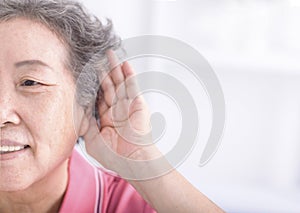 Closeup senior woman hearing loss , Hard of hearing