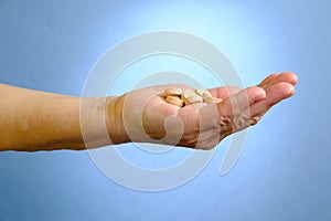 Closeup of senior woman's hand holding medications