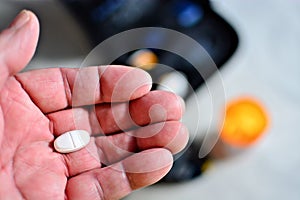 Closeup of seniors hand with one white pill