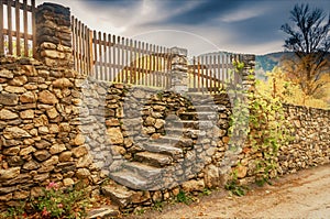 Closeup of a series of steps on a stone retaining wall in the countryside