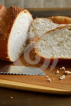 Closeup sesame seed loaf of bread on cutting board