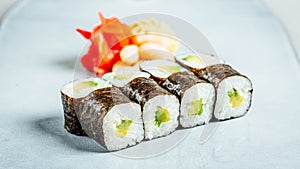 Closeup of a set of delicious fresh sushi rolls served on a white plate