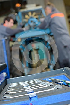 Closeup set spanners mechanics in background