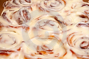 Closeup of several cinnamon buns.Beautiful fresh cinnamon rolls close-up on wooden grunge texture table. Fragrant