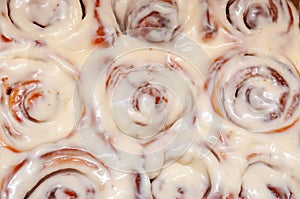 Closeup of several cinnamon buns.Beautiful fresh cinnamon rolls close-up on wooden grunge texture table. Fragrant