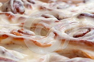 Closeup of several cinnamon buns.Beautiful fresh cinnamon rolls close-up on wooden grunge texture table. Fragrant