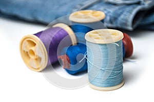 Blue sewing thread spool bobbins on white background