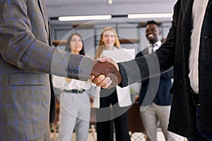 Closeup shaking hands of african and caucasian people