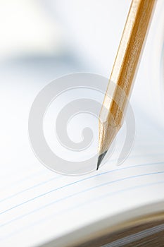 Closeup of sharp graphite pencil on white paper of notebook.  Concept of The National Day of Knowledge or International literacy