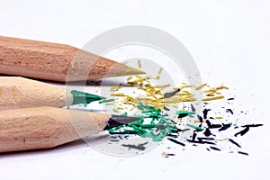 Closeup of sharpened colorful pencils with shavings isolated in the white background