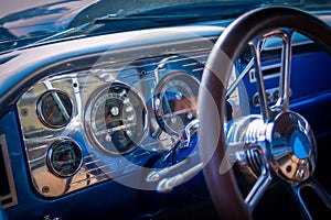 Closeup of shiny interior details of a vintage car under the lights