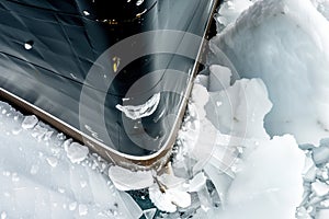 closeup of ships prow splintering thick ice layer