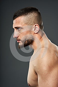 Bruised fighter on gray background