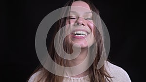 Closeup shoot of adult pretty caucasian female laughing with joy while looking at camera with background isolated on