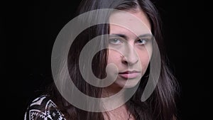 Closeup shoot of young attractive caucasian female face with green eyes opening and looking straight at camera