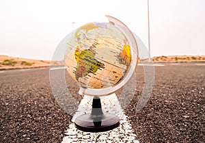 Closeup shot of a 3D globe model in the road with a blurred background