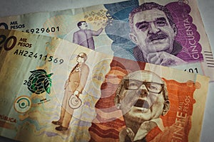 Closeup shot of 50 and 20 Columbian Pesos on a white background