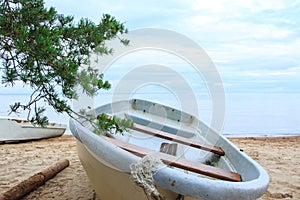 Closeup shot of abandoned fishing boats on sandy beach.