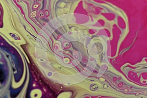 Closeup shot of an abstract background of poured colorful acrylic paint and oil mixture