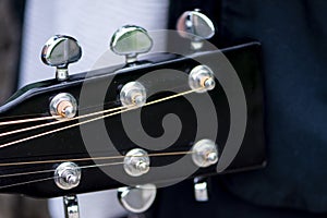 Closeup shot of acoustic black guitar tuners