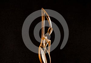 Closeup shot of an African traditional wooden statue on a black background