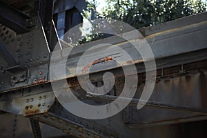 Closeup shot of an aged metal structure with large rusty rivets