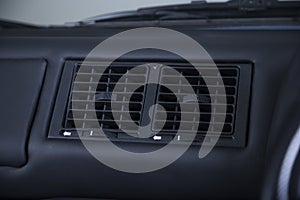 Closeup shot of an aircon on a dashboard in a car photo