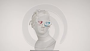 Closeup shot. Ancient marble bust statue of roman era woman in 3d glasses spinning round on a platform. Isolated on pink