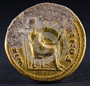 Closeup shot of an ancient Roman gold aureus coin of Emperor Tiberius, reverse