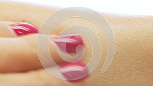 Closeup shot of an applying hand care moisturizer cream on the dry woman skin