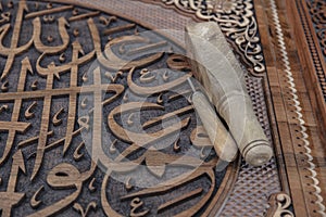 Closeup shot of Arabic calligraphy of a verse from the Quran