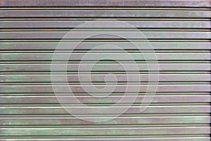 A closeup shot of automatic metal roller door used in factory, storage, garage, and industrial warehouse.