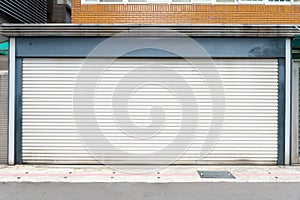 A closeup shot of automatic metal roller door used in factory, storage, garage, and industrial warehouse.