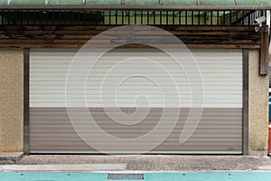 A closeup shot of automatic metal roller door used in factory, storage, garage, and industrial warehouse.