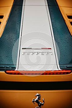 Closeup shot of the back end of a Ferrari 458 Speciale after rain with raindrops on it