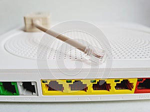 Closeup shot of a back of a modem router with colored network cable plugs