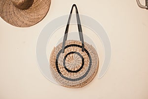 Closeup shot of a bag and a hat hanging from the wall