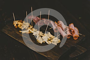 Closeup shot of baloney and sliced cheese on a wooden board