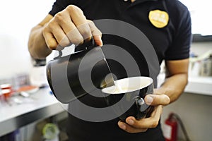 Closeup shot of barista's hands making a coffee