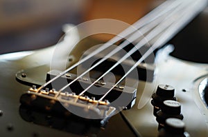 Closeup shot of a bass guitar bridge - Fender Jazz Bass style bridge