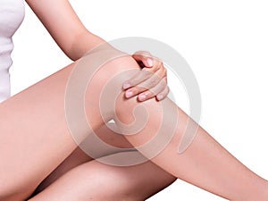 Closeup shot of beautiful female`s hand touching perfect hairless soft and silky long legs skin