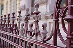 Closeup shot of the beautiful metal fences in front of a stone building