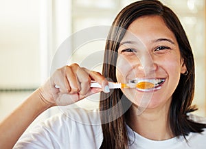 No one ever regrets brushing their teeth. Closeup shot of a beautiful young woman brushing her teeth.