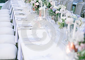 Closeup shot of a beautifully decorated table setting for an outdoor wedding reception