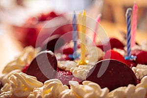 A closeup shot of a birthdaycake with a blurry backgroud