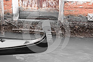 Closeup shot of a black gondola detail on a canal in Venice, Italy