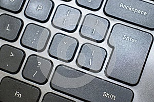 Closeup shot of a black laptop keyboard in use. photo